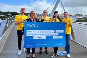 AWARE NI Head of Fundraising Leigh Osborne being presented with a cheque donation by FinTrU staff from its Derry office