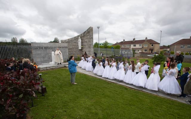 Fr. McFaul greets the Holy Child First Communion children to the grotto on Thursday.
