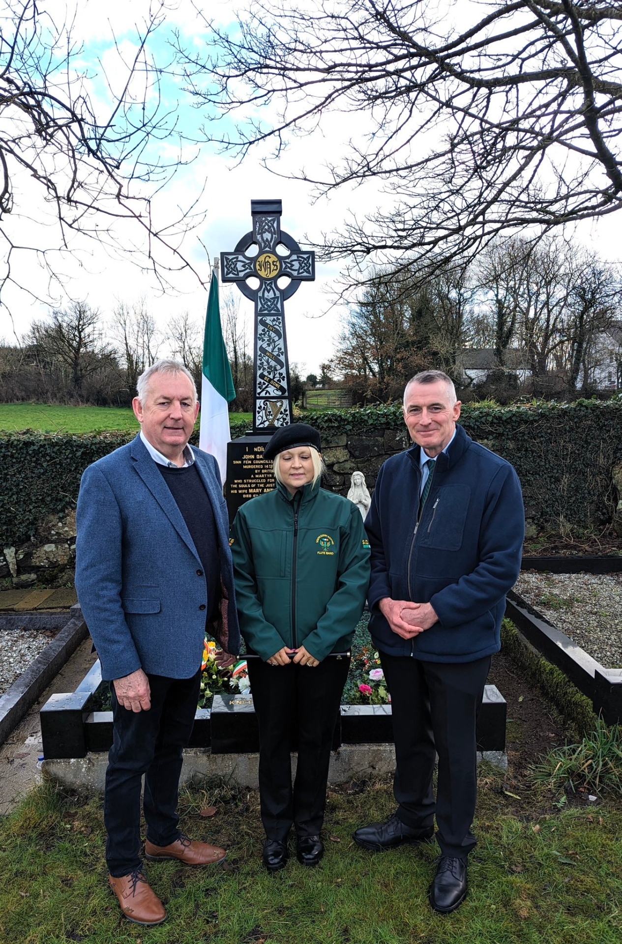 Cllr. Sean McPeake, Margaret Mullan and Declan Kearney pictured at grave of Cllr. John Davey.