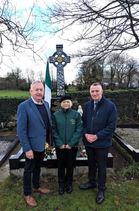 Cllr. Sean McPeake, Margaret Mullan and Declan Kearney pictured at grave of Cllr. John Davey.