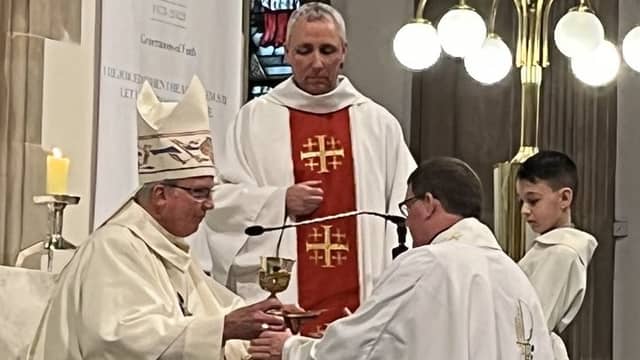 Bishop of Derry, Most Reverend Dónal McKeown ordains Ireland's newest priest Fr Michael McCaul. (Photograph courtesy of The Net.)