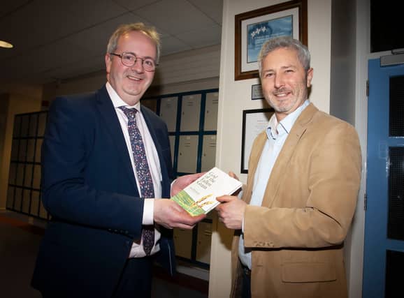 Mr. John Harkin, Acting Principal, Oakgrove Integrated College, receiving a copy of ‘God Of The Fallen Grain’ from Rev. Dr. Alex Wimberly, Corrymeela Community. (Photos: Jim McCafferty Photography)