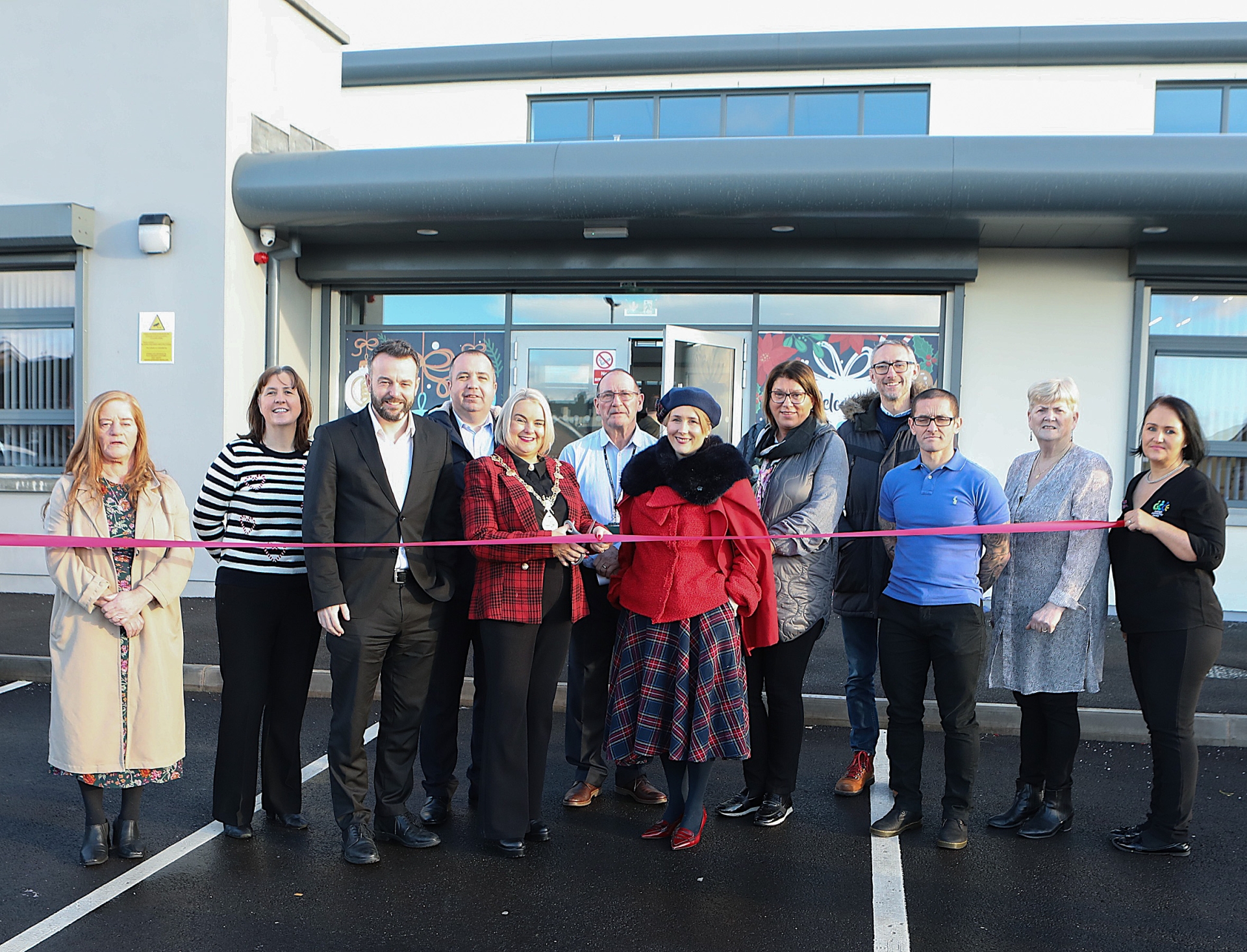Mayor of Derry and Strabane, Cllr Sandra Duffy, pictured with Moira Doherty, deputy secretary, Department for Communities, preparing to cut the ribbon to officially open the Galliagh Community Centre.