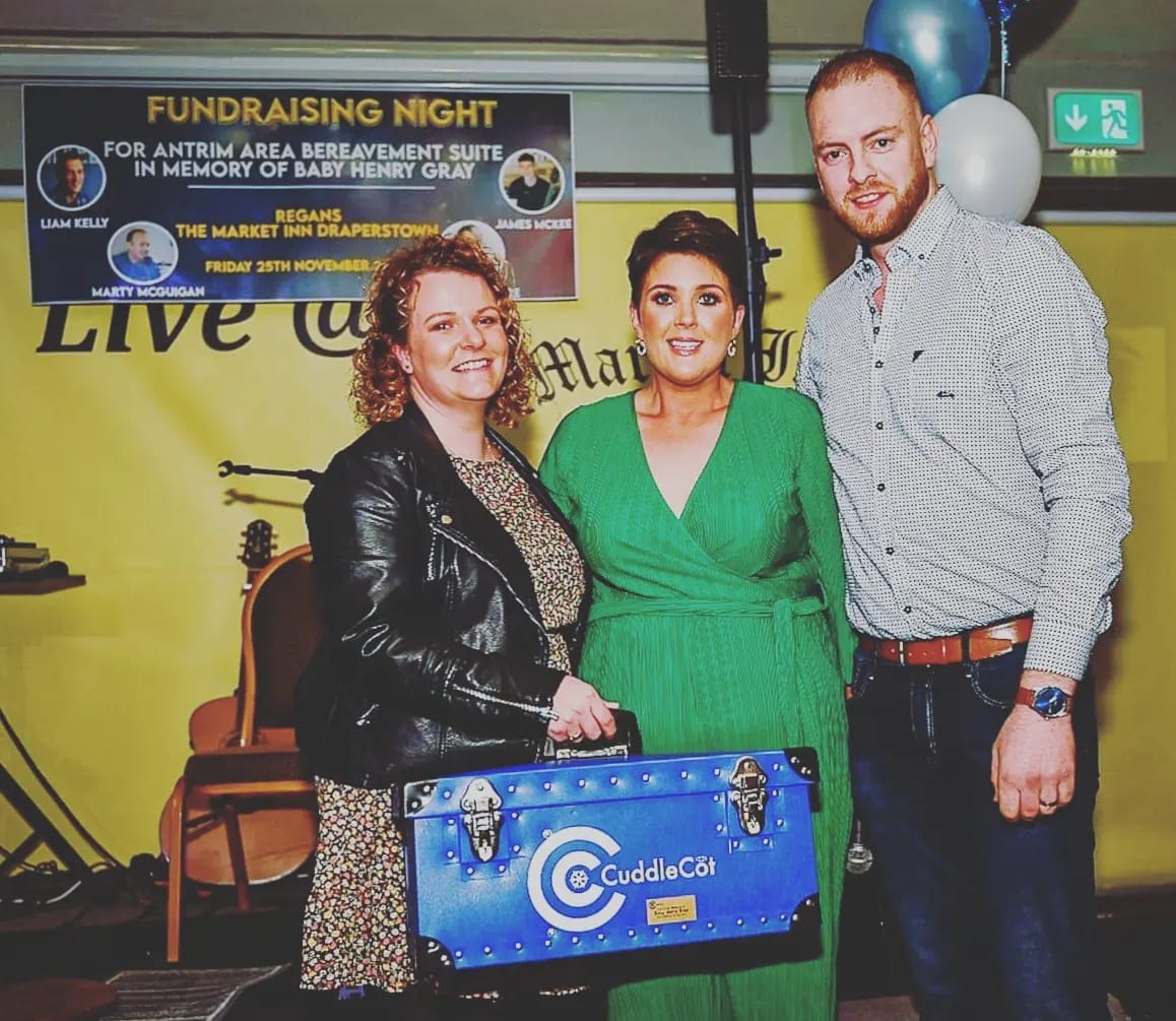 Louise and Harry Gray pictured presenting the Cuddle Cot to Midwife Fiona O'Kane.