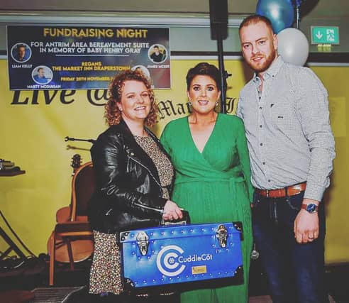 Louise and Harry Gray pictured presenting the Cuddle Cot to Midwife Fiona O'Kane.