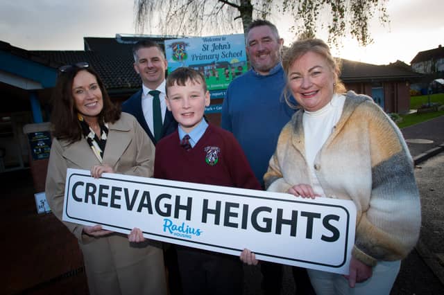 Pupil Jack Taylor alongside Bridie Doherty, Radius Housing, Andrew Lennon, Radius Housing, Raymond McCann, P. & K. McKaigue, and Mrs. Geraldine O’Connor, Principal, St. John’s Primary School, Derry.