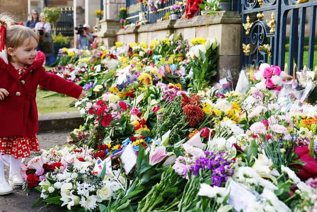 Banks of flowers at the gates of the royal palaces and in public parks grew, with thousands of well-wishers leaving poignant notes, pictures and gifts while pausing for quiet reflection on what the Queen meant to them.