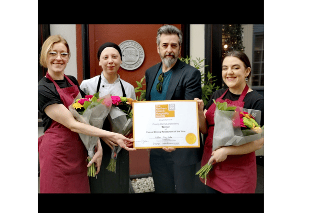 The wonderful staff at the Hidden City Cafe with winning certificate and flowers. L-R: Laura McDowell, Bekah Devine, JK McNicholl and Tori Messenger