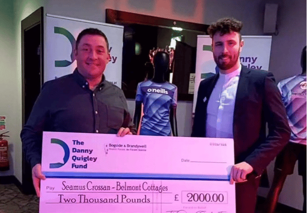 Danny Quigley donating one of the first donations from the DQ Fund to Seamus Crossan, Manager at Belmont Cottages in Derry