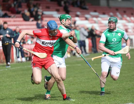 Derry Brendan Laverty pulls away from London's Paddy O'Toole.