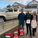 Pictured left to right; Darren Mulholland, Kieran, Caitlin and Emma-Rose McGuigan and Carina Moran with the defibrillators Kieran donated to the community.