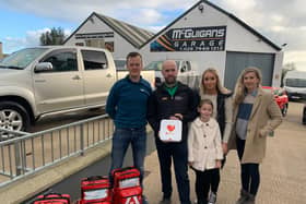 Pictured left to right; Darren Mulholland, Kieran, Caitlin and Emma-Rose McGuigan and Carina Moran with the defibrillators Kieran donated to the community.