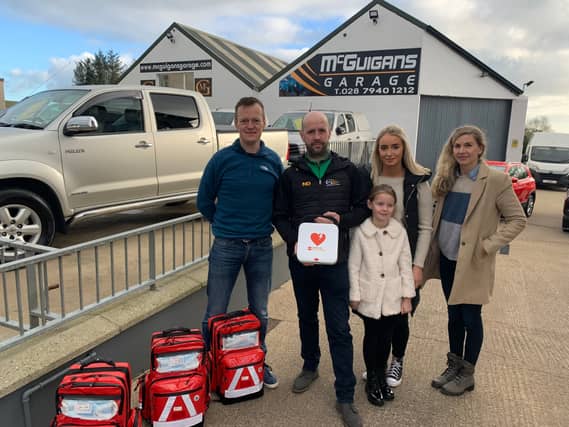 Pictured left to right; Darren Mulholland, Kieran, Caitlin and Emma-Rose McGuigan and Carina Moran with the defibrillators Kieran donated to the community.