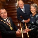 Brian Tierney making a presentation to Marie Lindsay. Also pictured is Mrs Lindsay's husband Collie. Photo by Jim McCaffertyl