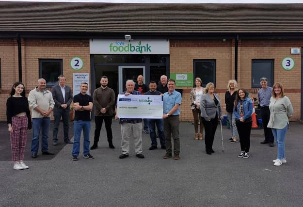 The singers hand over the money to the local food bank.