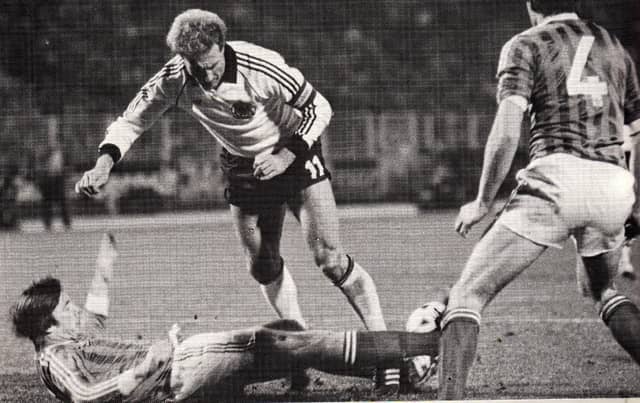 Gerry gets a tackle in on Karl-Heinz Rummenigge during Northern Ireland's 1-0 win over West Germany in Hamburg in a qualifier for the 1984 European Championships