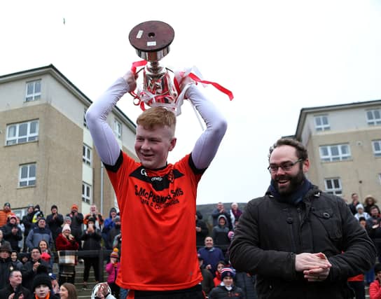Cormac Collins raised the cup after Lavey's win over Termon. (Pic: Seamus Loughran)