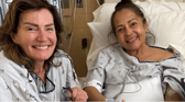 Eileen Kerlin Walsh & Christine Hernandez hold hands after the kidney transplant in April.