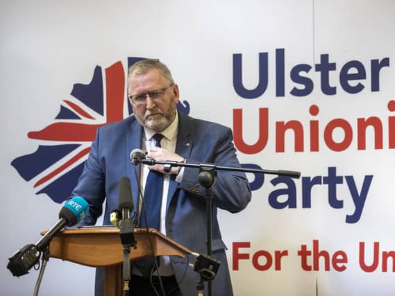 Doug Beattie in front of an UUP poster
