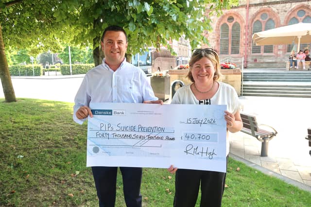 Former Mayor of Derry City and Strabane District Council, Councillor Ruairí McHugh presenting PIPS Charity Compliance and Operations Manager, Liz with a cheque for £40,700 following a year of fundraising.