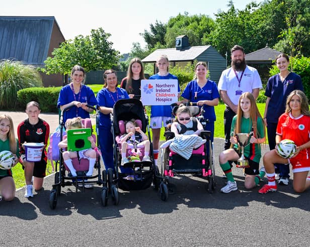 David Dixon, Community and Fundraising Relationship Manager at Northern Ireland Children's Hospice, and William Campbell, Director of the Budget Energy SuperCupNI, are pictured with patients from Northern Ireland Children's Hospice and players from Glentoran, Crusaders, Linfield and Cliftonville following the announcement of the Hospice as the Official Charity Partner of the 2026 Budget Energy SuperCupNI ahead of this summer's Girls' Tournament.