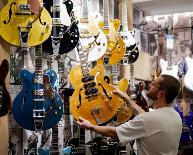 Man looking at guitars in a store