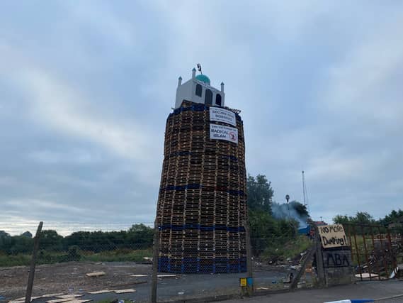 A bonfire pyre with a replica mosque on the top