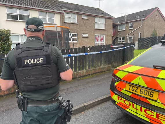 A police officer and car outside a house in Dungannon