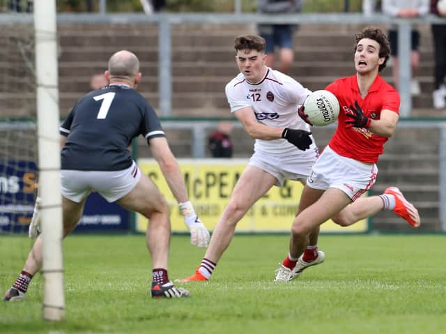 Magherafelt Conall Higgins with Conor Coyle of Slaughtneil during the Derry Senior Football Championship match at Owenbeg.