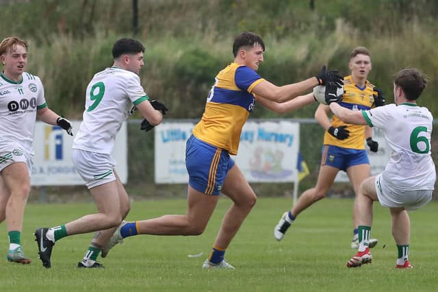 Limavady's Tom Deery with Taidhg Coyle, Oisin McCloskey and James McLaughlin of Craigbane during the Derry IFC match on Saturday.