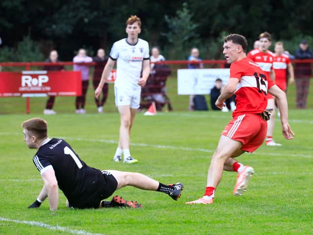 Castledawson’s keeper Ronan Rafferty on the ground as Drumsurn’s Shea Murray turns away after scoring a goal.