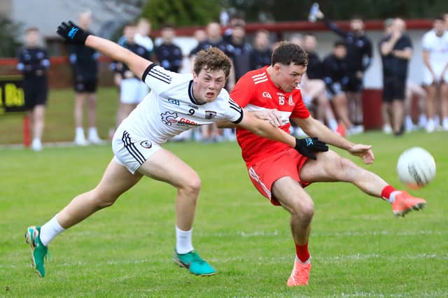 Drumsurn’s Shea Murray gets ready to score another point despite St. Malachy's Castledawson’s Colman Bradley effort trying to block, in the McFeely Group Intermediate Football Championship Group C Round 1 at Drumsurn.