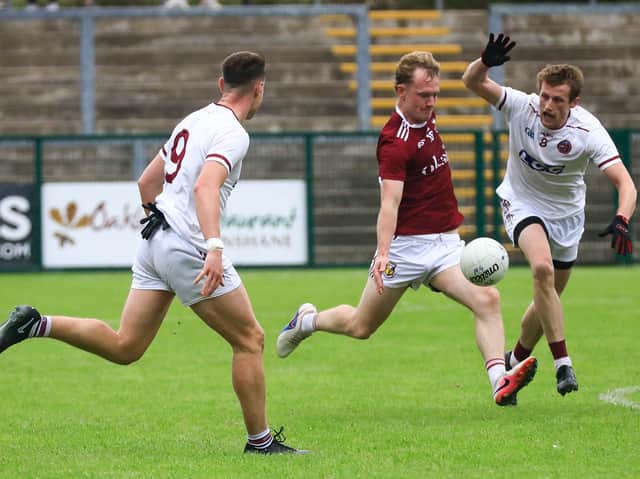 Slaughtneil’s Brendan Rodgers attempts to block Banagher’s Tiarnan Moore kick towards the target.