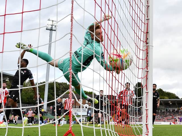 Dundalk goalkeeper Enda Minogue is beat by the header of Patrick McClean.