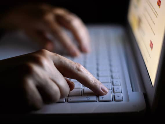 Hands on a laptop keyboard