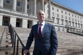 Jon Burrows poses on the steps of the Parliament Buildings after he was signed in at Stormont