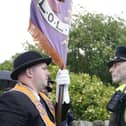 An Orange Order supporter and police officer during a parade