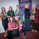 The Mayor Grace Ui Niallais, Rhonda Murphy, Manager, Derry Well Women and Phil Mahon, Chair, presenting bouquets of flowers to Annette Keys, Alice Rigney, Marina Sweeney and Dympna Redden at Tuesday night's AGM. 
