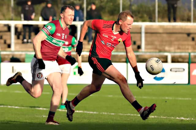 Greenlough’s Brian McCallion solos the ball up the field in the semi-final against Eoghan Rua.