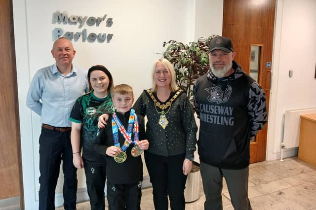 Leon Williamson pictured with Mayor of Causeway Coast and Glens, Cllr Dawn Huggins, his mum, Melanie and coach Peter McClay from Team Ryano Causeway, also included is Cllr Philip Anderson.