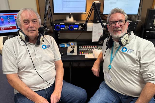 Causeway Hospital Radio volunteers Mervyn Nicholl and Richard Brown behind the desk in the broadcasting studio.