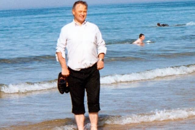 Fr Paddy O'Kane paddling in the water at Culdaff Beach. A new book is being written about the beloved late priest, with people being asked to share their memories of him.