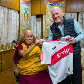 Greg McLaughlin presents His Holiness the Dalai Lama a Derry GAA jersey.