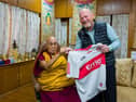 Greg McLaughlin presents His Holiness the Dalai Lama a Derry GAA jersey.