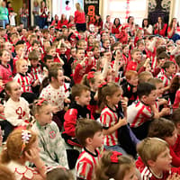 IN PICTURES: Red and white army takeover Derry's Hollybush PS
