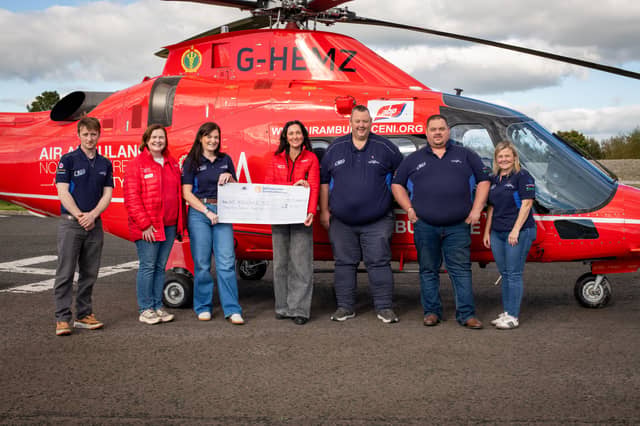 Members of the committee pictured handing over a cheque to Air Ambulance NI.