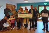 Seamus McCloskey, Dungiven, along with family and friends with a cheque for £13,709.03, raised from his 26 in 26 challenge.