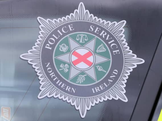 PSNI badge in police car window