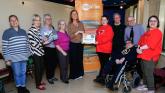 Yvonne Norris presenting donation to Bernie Shiels, chairperson, Stage Beyond. L-R: Becca Barnes, Mary Doherty, Sadie Harkin & Clare Moore, Susannah McKay, Frank Neils, Darren Bond & Kevin Harkin.