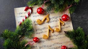 People in Derry being encouraged to take part in a Christmas carol service in their streets